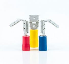 A red, a yellow and a blue insulated piggyback connector, without sleeve, standing upright, on a white background.